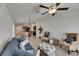 Bright and open-concept living room with tile flooring, wicker furniture set, kitchen view and ceiling fan at 7236 Salt River Ave, Sun City Center, FL 33573