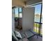 Inviting balcony with outdoor seating, offering serene views of the water and tropical foliage at 7465 Bay Island S Dr # 211, South Pasadena, FL 33707
