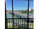 Balcony view showcases the scenic bridge over the water and nearby building complexes in the distance at 7465 Bay Island S Dr # 211, South Pasadena, FL 33707