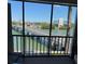 Scenic balcony view features a bridge over the tranquil waters, connecting to the buildings across the waterway at 7465 Bay Island S Dr # 211, South Pasadena, FL 33707