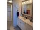 Bathroom featuring a vanity with decorative mirror and walk-in shower at 7465 Bay Island S Dr # 211, South Pasadena, FL 33707