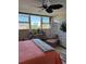 Bright bedroom featuring a ceiling fan, large windows, and comfortable seating at 7465 Bay Island S Dr # 211, South Pasadena, FL 33707