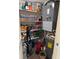 Well-stocked pantry and mechanicals with shelves full of food and household items, next to a water heater at 7465 Bay Island S Dr # 211, South Pasadena, FL 33707