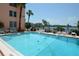 Enjoy the community pool with lounge seating and stunning waterfront views at 7465 Bay Island S Dr # 211, South Pasadena, FL 33707