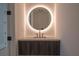 Bathroom vanity featuring an illuminated round mirror and modern fixtures at 777 3Rd N Ave # 1308, St Petersburg, FL 33701