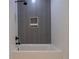 Bathroom featuring modern tub and shower combination, with gray and white tiled walls at 777 3Rd N Ave # 1308, St Petersburg, FL 33701