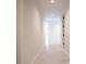 Well-lit hallway featuring modern white walls and stylish tile flooring leading to other areas at 777 3Rd N Ave # 1308, St Petersburg, FL 33701