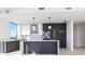Contemporary kitchen featuring stone countertops, stainless appliances, and stylish pendant lighting at 777 3Rd N Ave # 1308, St Petersburg, FL 33701