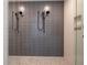 Contemporary shower featuring gray subway tile walls, pebble flooring, and sleek black fixtures at 777 3Rd N Ave # 1308, St Petersburg, FL 33701