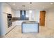 Modern kitchen features sleek white cabinets, stainless steel appliances, and a stylish island with a gray countertop at 777 3Rd N Ave # 1501, St Petersburg, FL 33701