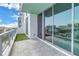 Balcony features a partial grassy area alongside a glass sliding door leading into the condo at 777 3Rd N Ave # 707, St Petersburg, FL 33701