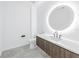 Modern bathroom with a rounded mirror, sleek vanity, and stylish tiling at 777 3Rd N Ave # 707, St Petersburg, FL 33701