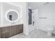 Bright bathroom features a modern vanity with illuminated mirror and a tiled shower-over-tub combination at 777 3Rd N Ave # 707, St Petersburg, FL 33701