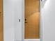 Modern condo front door with matte black handle and peephole, white trim, and light wood finish at 777 3Rd N Ave # 707, St Petersburg, FL 33701