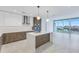 Modern open kitchen with island, stainless steel appliances, white and wood cabinets, and large windows at 777 3Rd N Ave # 707, St Petersburg, FL 33701