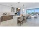 Open kitchen with island, stainless appliances, white cabinets, and access to a bright living area at 777 3Rd N Ave # 707, St Petersburg, FL 33701