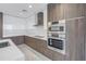 Modern condo kitchen features stainless steel appliances, two-tone cabinets, and quartz countertops at 777 3Rd N Ave # 707, St Petersburg, FL 33701