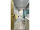 Functional bathroom with a tub and shower, white vanity, tile flooring, and a neutral color scheme at 8718 Arrowhead Dr, Hudson, FL 34667