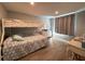 This bedroom features a bunk bed, wood-look flooring, and a neutral color palette, creating a cozy space at 8718 Arrowhead Dr, Hudson, FL 34667