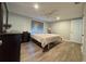 Comfortable bedroom with ceiling fan, wood-look flooring and a large window for plenty of natural light at 8718 Arrowhead Dr, Hudson, FL 34667