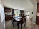Cozy dining area with a modern table set, beautiful flooring, and natural light from nearby windows and doors at 8718 Arrowhead Dr, Hudson, FL 34667