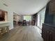 Bright dining room with wood flooring, a stylish table set, and French doors leading to the backyard at 8718 Arrowhead Dr, Hudson, FL 34667