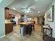 Spacious open-concept kitchen and living area with hardwood flooring, island seating, and recessed lighting at 8718 Arrowhead Dr, Hudson, FL 34667