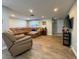 Spacious living room with hardwood flooring, a comfortable leather sectional, and recessed lighting at 8718 Arrowhead Dr, Hudson, FL 34667