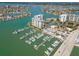 Aerial view of waterfront condominiums, marina, and beautiful bay views at 9495 Blind Pass Rd # 308, St Pete Beach, FL 33706