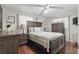 Comfortable bedroom featuring wood floors, ceiling fan, and ample closet space at 111 Inwood Cir, Brandon, FL 33510