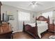 Bedroom with wood floors, white comforter, ceiling fan, and bright natural light at 111 Inwood Cir, Brandon, FL 33510