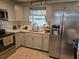 Bright kitchen with stainless steel appliances and white quartz countertops at 111 Inwood Cir, Brandon, FL 33510