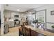 Well-equipped kitchen with stainless steel appliances and gray cabinets, connected to dining area at 111 Inwood Cir, Brandon, FL 33510