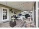 Inviting covered patio with tile flooring, string lights, and outdoor dining area at 111 Inwood Cir, Brandon, FL 33510