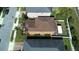 Aerial view of a well-maintained residential home showcasing the landscaping and roof details at 11656 Lake Blvd, New Port Richey, FL 34655
