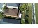 Aerial view of a home featuring a brown roof and manicured backyard with white privacy fence at 11656 Lake Blvd, New Port Richey, FL 34655