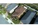 Aerial view of a residential home with a dark brown roof and mature landscaping in a suburban neighborhood at 11656 Lake Blvd, New Port Richey, FL 34655