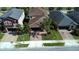 Aerial view of a well-maintained home featuring a manicured lawn and an inviting brick driveway at 11656 Lake Blvd, New Port Richey, FL 34655