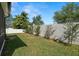 This backyard features a privacy fence and mature trees, offering both seclusion and natural beauty at 11656 Lake Blvd, New Port Richey, FL 34655