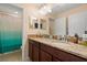Bathroom vanity with double sinks, granite countertop, dark wood cabinets, and a separate shower/tub at 11656 Lake Blvd, New Port Richey, FL 34655