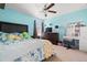 Bedroom with blue accent wall, ceiling fan, and a window providing natural light at 11656 Lake Blvd, New Port Richey, FL 34655