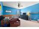 room with bright blue walls, ceiling fan, and a window providing natural light at 11656 Lake Blvd, New Port Richey, FL 34655