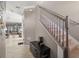 Inviting entryway showcasing a staircase, tiled flooring, and an open view of the living area at 11656 Lake Blvd, New Port Richey, FL 34655
