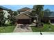 Charming two-story home with a brick driveway, well-maintained lawn and mature landscaping at 11656 Lake Blvd, New Port Richey, FL 34655