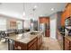 Gourmet kitchen featuring a granite island, stainless steel appliances, and ample cabinet space at 11656 Lake Blvd, New Port Richey, FL 34655