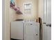 Efficient laundry room with appliances, shelving, and natural light, making laundry chores a breeze at 11656 Lake Blvd, New Port Richey, FL 34655