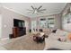 Comfortable living room with large sectional sofa, fireplace, and abundant natural light at 11656 Lake Blvd, New Port Richey, FL 34655