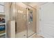Walk-in shower featuring glass enclosure, tiled walls, and rainfall showerhead at 11656 Lake Blvd, New Port Richey, FL 34655