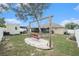 Spacious backyard featuring a swing, outdoor seating, and lush landscaping perfect for outdoor enjoyment and entertaining at 13416 Algoma Ave, Spring Hill, FL 34609