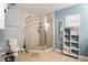 Bright bathroom with a glass-enclosed shower, storage shelves, and neutral tile flooring at 13416 Algoma Ave, Spring Hill, FL 34609